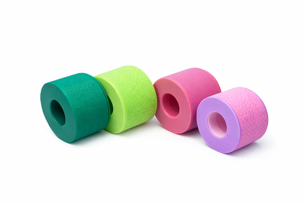 Rolls of wide silicone lash tape in four colors